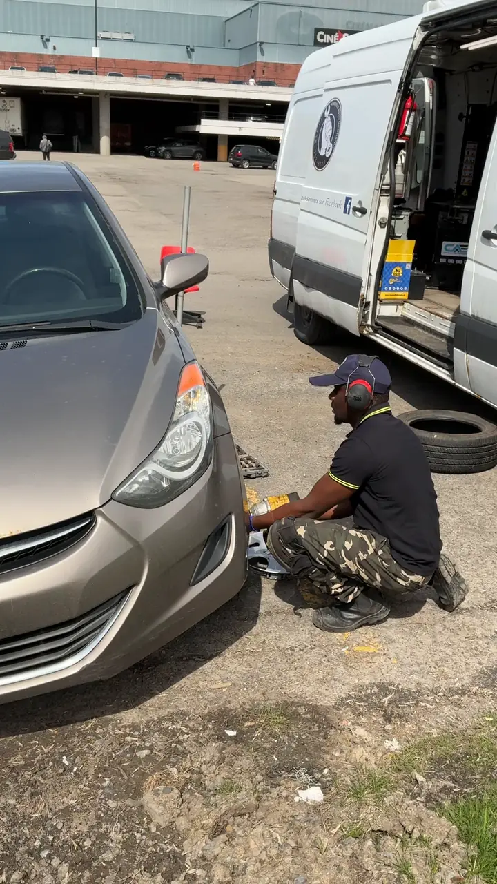 Elie changing a tire on site next to the Alimotorsforall service van