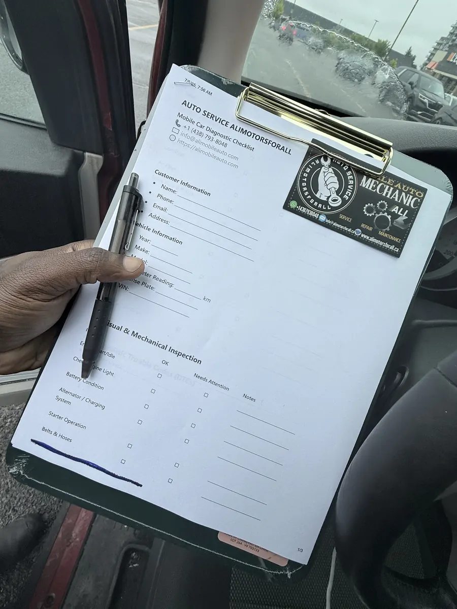 Clipboard with the Auto Service Alimotorsforall mobile car diagnostic checklist held inside a customer’s car