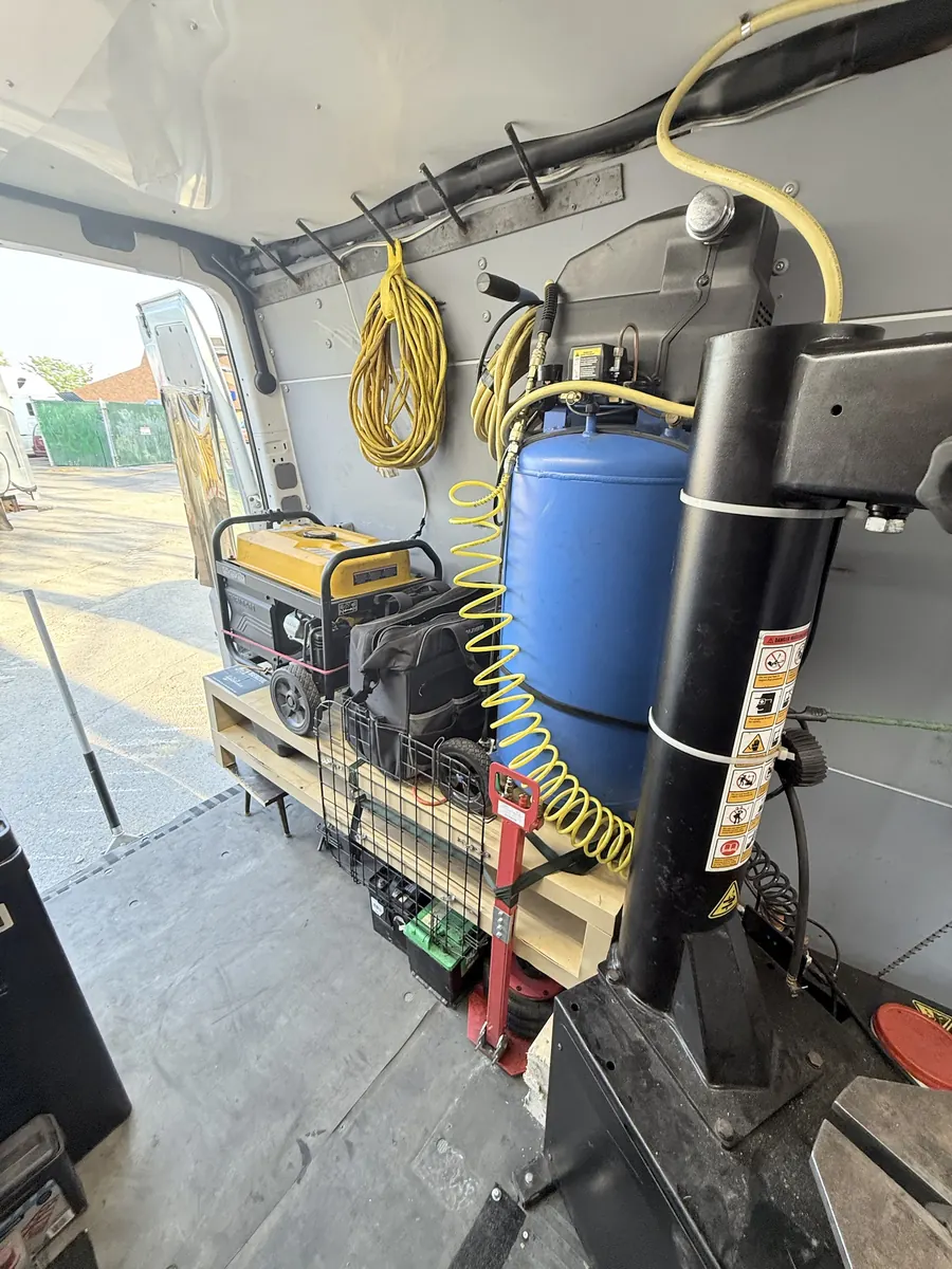 Inside the service van: generator, air compressor tank and hoses